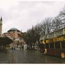 Brown Bigbus Istanbul Traveling on Road Near Brown Dome Building