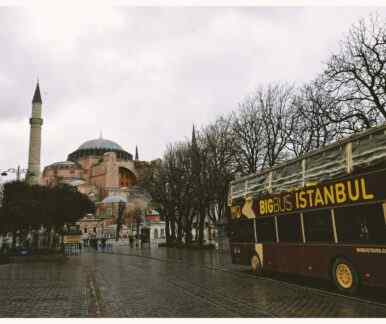 Brown Bigbus Istanbul Traveling on Road Near Brown Dome Building